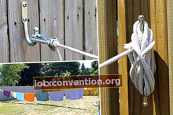 Sebuah tali jemuran direntangkan di antara 2 pagar di taman untuk mengeringkan pakaian.