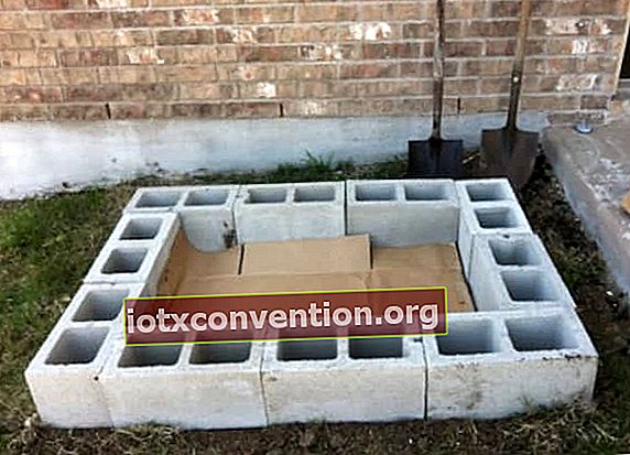 隆起した菜園を作るには、雑草が生えないように、燃えがらブロックを置き、次に段ボール箱を置きます。